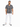 A man stands confidently in a patterned black and white shirt, paired with fitted white jeans and stylish sneakers.