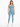 A woman stands confidently in a light blue one-shoulder bodysuit paired with matching leggings and white sneakers.