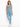 A woman poses in a one-shoulder top and matching leggings, showcasing a soft blue color and sporty style.