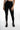 A person wearing form-fitting black leggings paired with stylish black ankle boots, standing against a white background.
