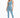 A model poses in a light blue one-shoulder crop top paired with matching high-waisted leggings and white sneakers.