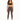 A woman stands confidently in fitted brown leggings paired with a dark sports bra and stylish sneakers.