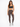 A woman stands confidently in fitted brown leggings and a dark sports bra, paired with stylish sneakers.