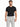 A man wearing a fitted black t-shirt paired with light gray trousers featuring a chain detail.