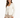 A woman in a fitted cream jacket paired with a white top and beige trousers, showcasing a stylish, professional look.