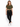 A woman stands confidently in a cropped olive green top, black leggings, and white sneakers against a plain background.