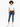 A young woman with curly hair wears a cropped white top and fitted blue jeans, paired with white sneakers.