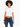 A model with curly hair wears a white cropped top paired with dark blue high-waisted jeans.