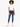 A young woman with curly hair wears a cropped white t-shirt and dark blue jeans, paired with white sneakers.