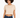 A woman with curly hair wears a cropped beige top paired with dark blue jeans, showcasing a casual style.