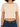 A cropped beige top with rolled short sleeves, paired with dark blue high-waisted jeans.