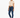 A model poses in a cropped beige top, dark skinny jeans, and white sneakers against a plain background.