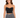 Black cropped top with chain straps, paired with a patterned black and white skirt, worn by a model.
