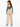 A woman with long hair wears a teal cropped top and beige wide-leg pants, showcasing a stylish back view.