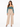 A model poses in a fitted teal crop top with long sleeves, paired with high-waisted beige wide-leg trousers.