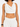 Cropped top with a draped neckline, paired with relaxed-fit pants, showcasing a stylish and casual look.