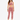 A model poses in a soft, pink velvet crop top and matching joggers, paired with white sneakers.