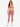 A model poses in a soft, pink velvet crop top and matching joggers, paired with white sneakers.