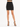A fitted black skirt paired with strappy black heels, showcasing a sleek silhouette and modern style.