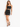 A model poses in a black crop top and matching fitted skirt, paired with strappy high-heeled sandals.