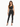 A model poses in a fitted black ribbed crop top and matching high-waisted pants with side slits.