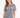 A woman poses in a gray marble-patterned tee featuring hand gestures spelling "LOVE" in white.