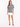 A model wearing a gray graphic tee with hand symbols and the word "LOVE," paired with a white skirt.