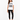 A woman stands wearing a white t-shirt with a zebra print graphic, paired with black leggings and sneakers.