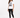 A woman stands wearing a white graphic tee with a zebra print design, paired with black leggings and sneakers.
