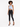A model poses in a light blue ribbed crop top with cut-out details, paired with black skinny jeans and heels.