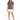 A woman stands confidently in a gray t-shirt with a stylish graphic, paired with a white skirt and black heels.