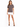A woman stands confidently in a gray t-shirt with a stylish graphic, paired with a white skirt and black heels.