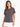 Woman wearing a gray short-sleeve tee with a stylish graphic design on the front, paired with a white skirt.