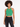 A model wearing a green ribbed crop top with a halter neck and keyhole detail, paired with black jeans.