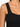 Close-up of a black ribbed top featuring wide straps and a fitted bodice, highlighting its textured fabric.