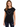 A woman wearing a black short-sleeve shirt with a white heart graphic, paired with distressed jeans.
