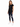 A woman stands wearing a black short-sleeve top with a heart design, paired with distressed skinny jeans and white sn...