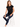 A woman sits on a white stool wearing a black sleeveless top with a heart design, paired with distressed blue jeans a...