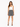 A model wearing a fitted white tank top paired with a black and white leopard print skirt and strappy black heels.