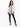 A model poses in a sheer white lace top with a black collar, paired with black fitted pants featuring slits.