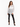 A model wearing a sheer white lace top with a button-down front, paired with black fitted pants featuring slits.