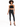 A model poses in a black lace halter top and high-waisted black skinny jeans, paired with strappy heels.