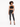 A model poses in a black crochet halter top, paired with high-waisted black skinny jeans and strappy heels.