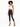 A model poses in a cropped, lace halter top paired with high-waisted black skinny jeans and strappy heels.