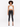 A model poses in a halter-style cropped top with a textured pattern, paired with black skinny jeans and heels.