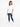 A woman stands in a relaxed pose wearing a white short-sleeve tee and distressed blue jeans with white sneakers.