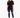 A woman stands confidently in a black oversized tee paired with distressed blue jeans and white sneakers.