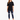 A woman stands confidently in a black oversized tee paired with distressed blue jeans and white sneakers.