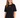 A woman wearing a black oversized tee with short sleeves and a simple white text design, paired with distressed jeans.