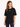 A woman wearing a black oversized tee with short sleeves and a simple white text design, paired with distressed jeans.